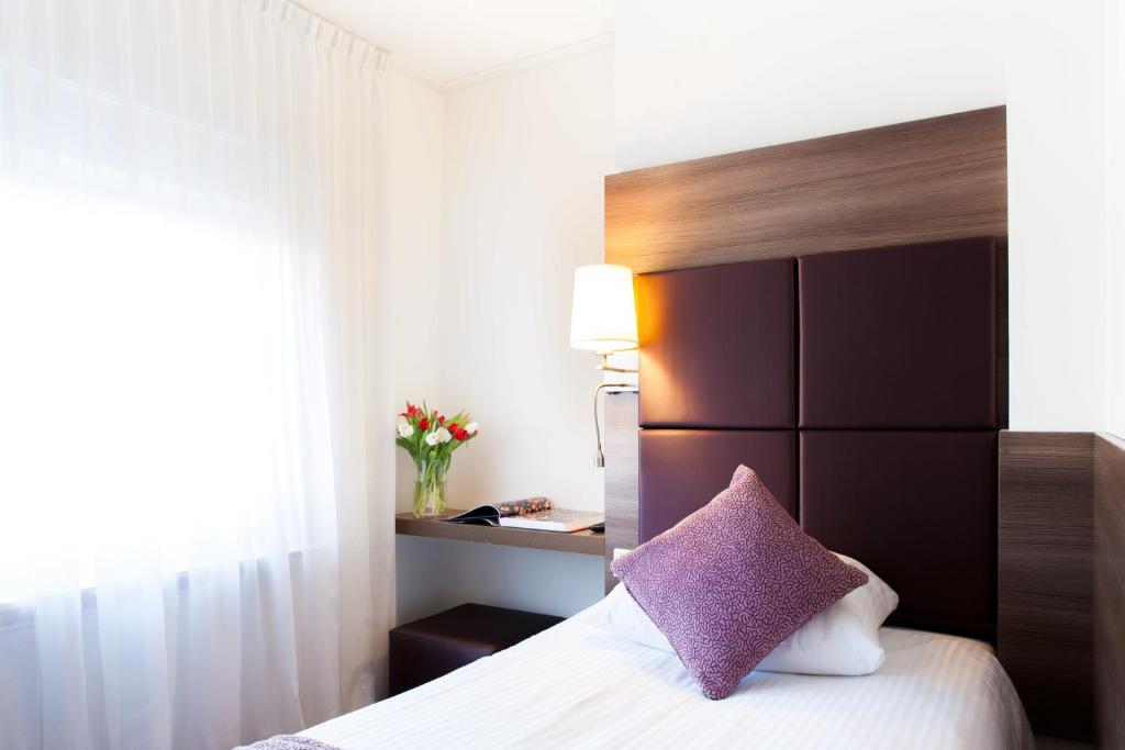 Postel nebo postele na pokoji v ubytování Hotel Victorie