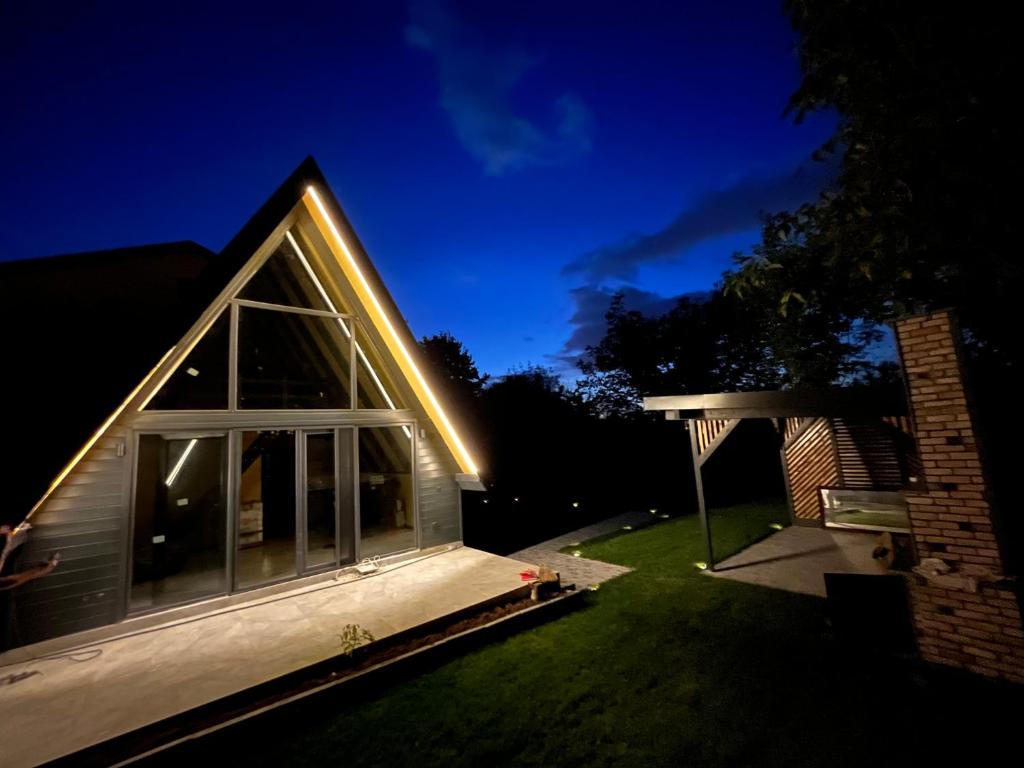 a house with a lit up front yard at night at Ensagardenbungalov in Kartepe