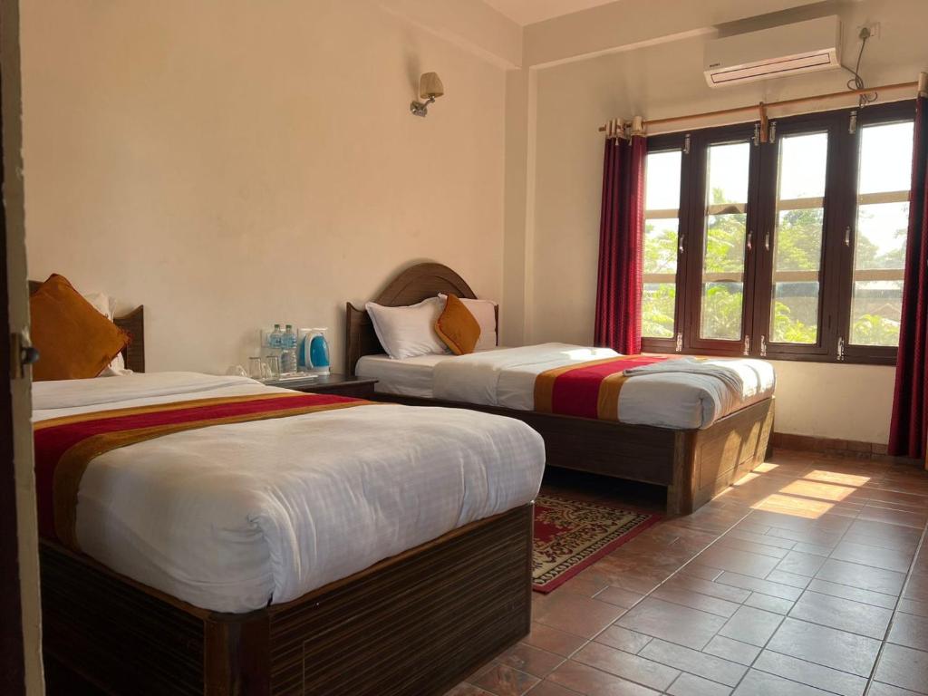 Letto o letti in una camera di Chitwan Park Village