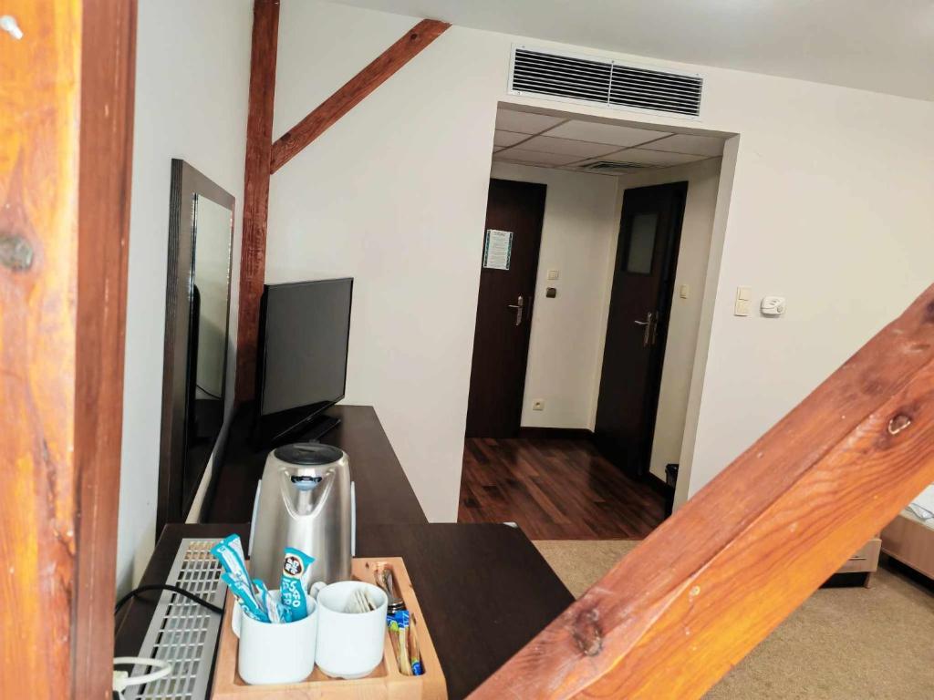 a room with a staircase with a table with toothbrushes at Mąka i Magia Obiady domowe Hotel in Zambrów