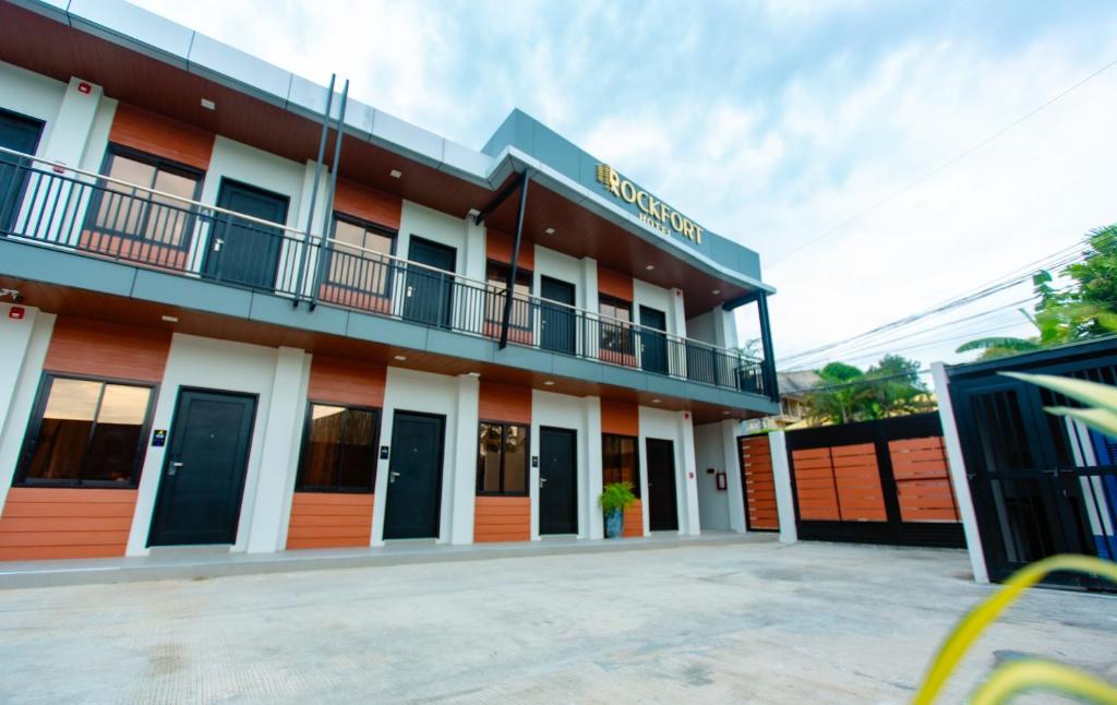 a building with a parking lot in front of it at Rockfort Hotel in Cotabato