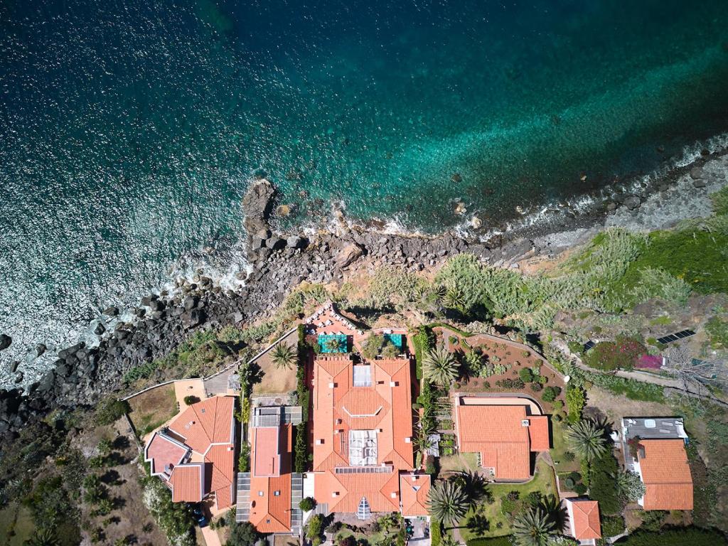 una vista aérea de una casa junto al océano en Inn & Art Madeira, en Caniço