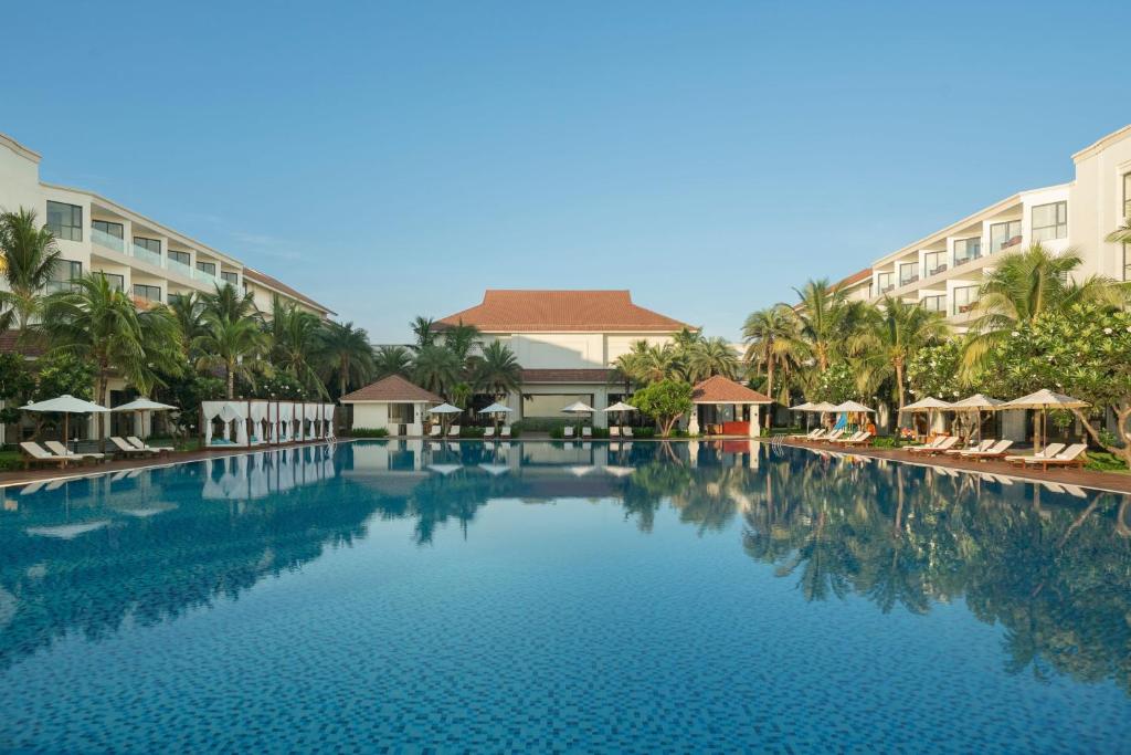 a large swimming pool in front of a hotel at Renaissance Hoi An Resort & Spa in Hoi An