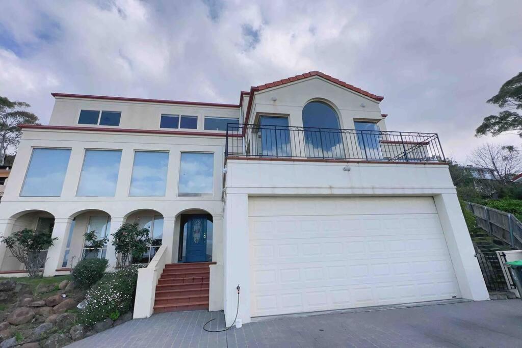 una gran casa blanca con garaje en Millions View - Hobart, en Sandy Bay