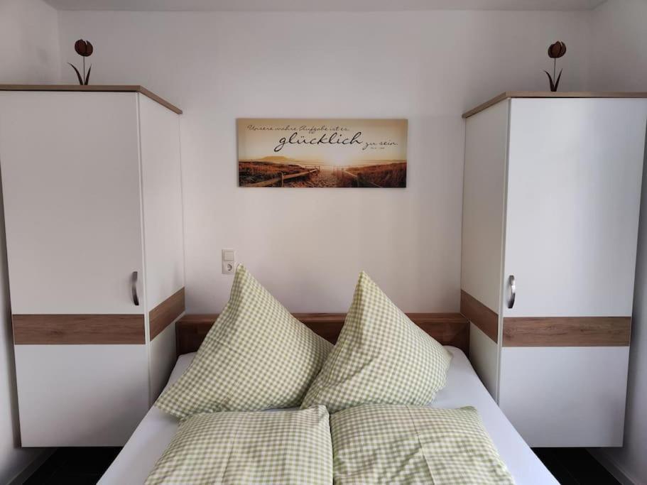 a bedroom with two beds and a picture on the wall at Else' s Stübchen in Welling
