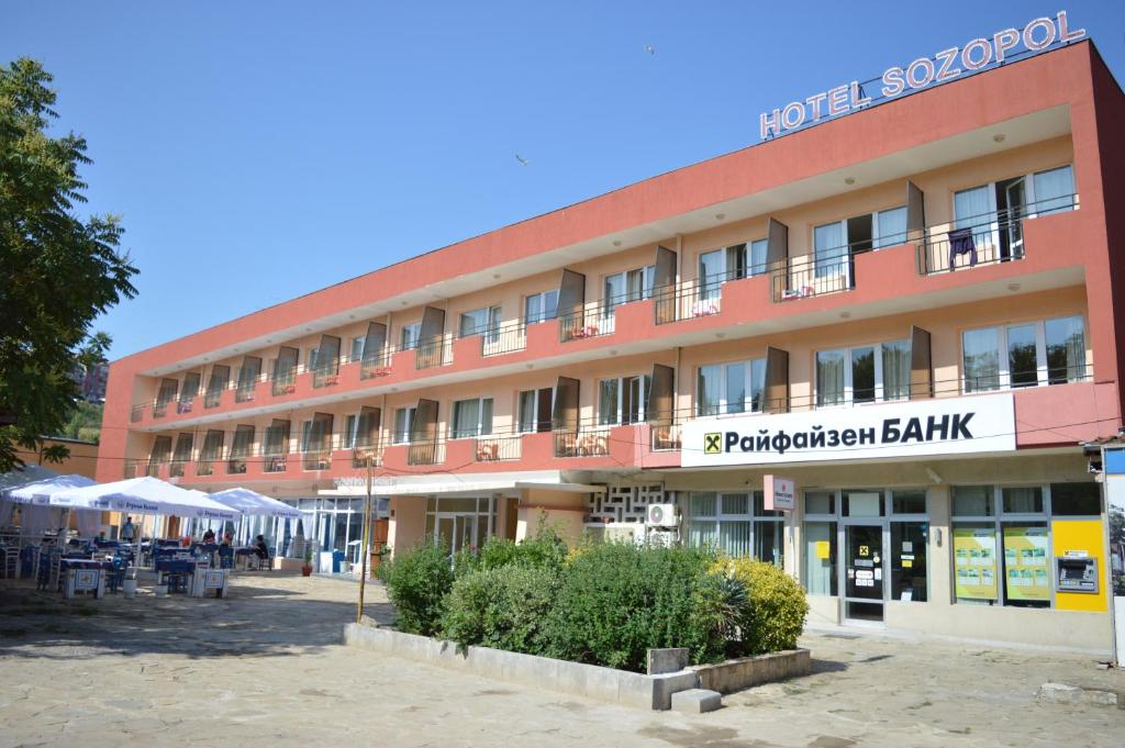 a large red building with a sign for a hotel at Hotel Sozopol in Sozopol