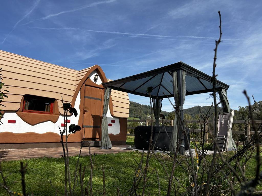 een huis met luifel in een veld naast bij Glamping PEC - All Inclusive light in Selnica ob Dravi