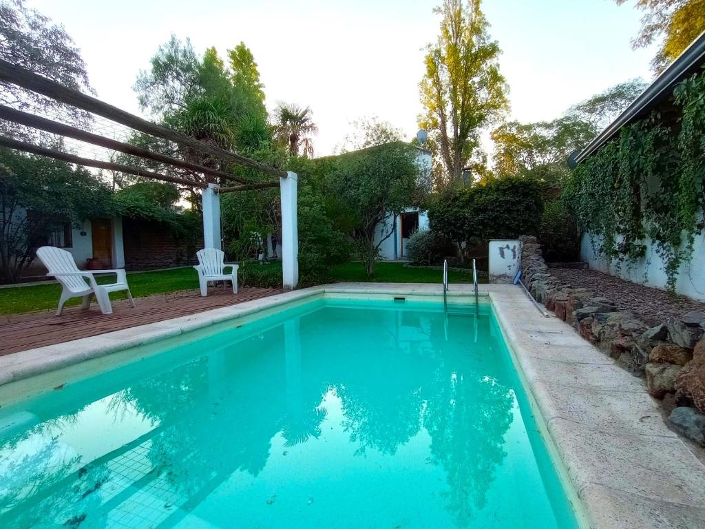 una piscina con pérgola junto a una casa en Aires de Coria con parking en Chacras de Coria