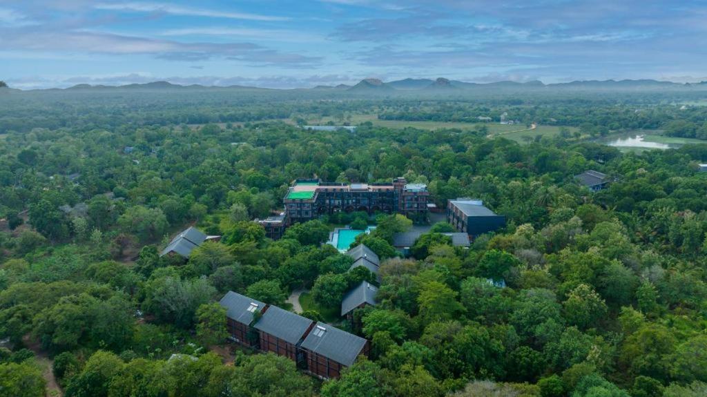 an aerial view of a building in the middle of a forest at Covanro Sigiriya - Brand New Luxury Hotel in Sigiriya