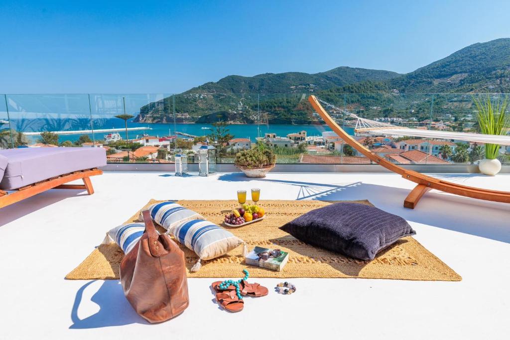 a view of the ocean from the balcony of a house at To Nissi in Skopelos Town
