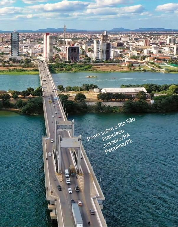 a bridge over the water with cars on it at Kitnet Vila Marcela in Petrolina