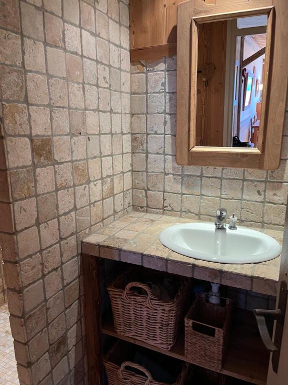 a bathroom with a sink and a mirror at Appartement cosy, esprit chalet avec jolie vue in Saint-Gervais-les-Bains