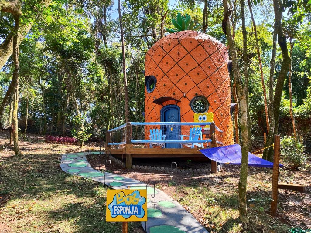 an orange iguana play structure in a park at Casa do Bob Esponja, Vila Mágica in Bueno Brandão