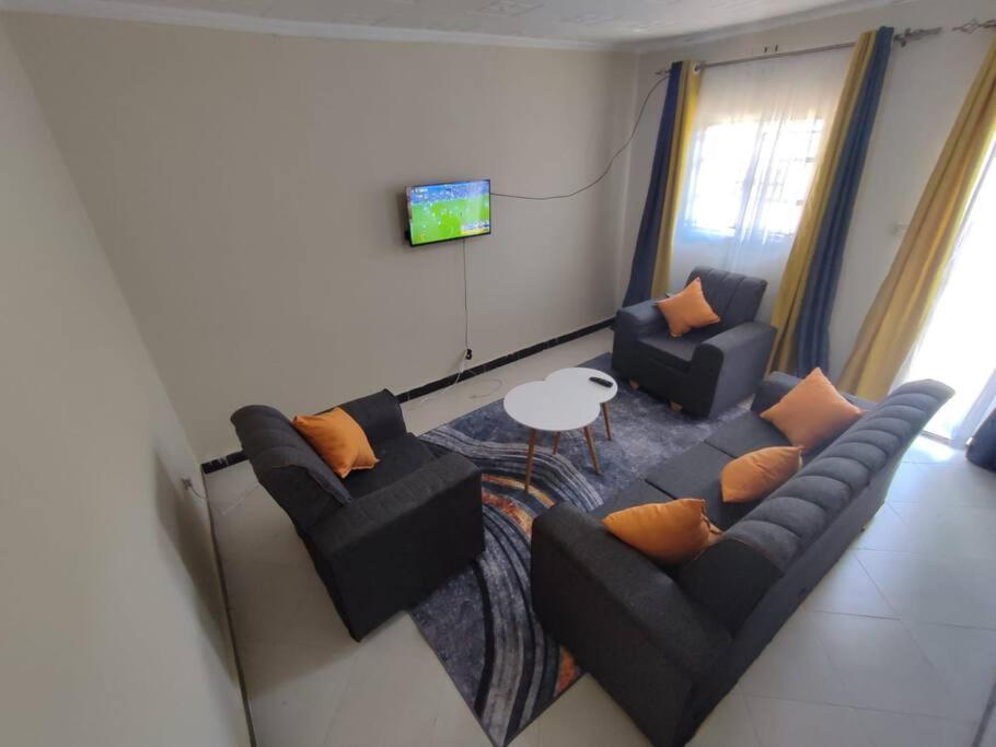 a living room with two couches and a table at consortium apartments in Bungoma