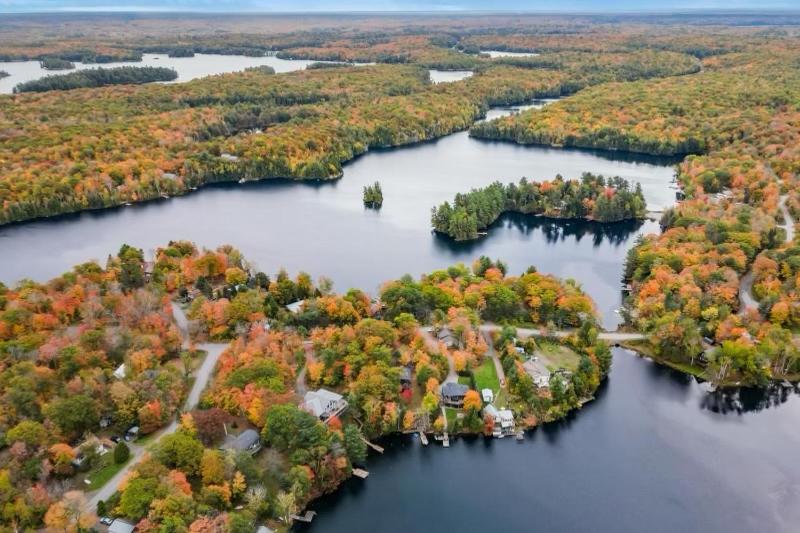 an aerial view of a lake with trees in autumn at 3 bedrooms waterfront Cottage in Parry Sound
