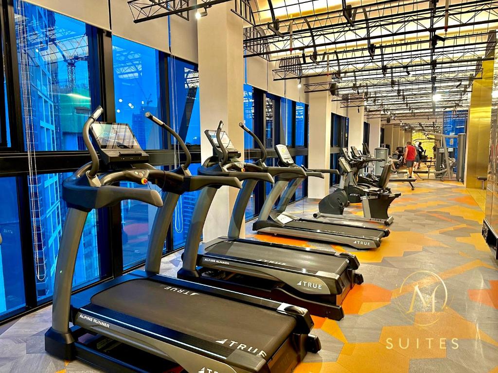 a row of cardio machines in a gym at Scarletz Suites KLCC by M Suites in Kuala Lumpur