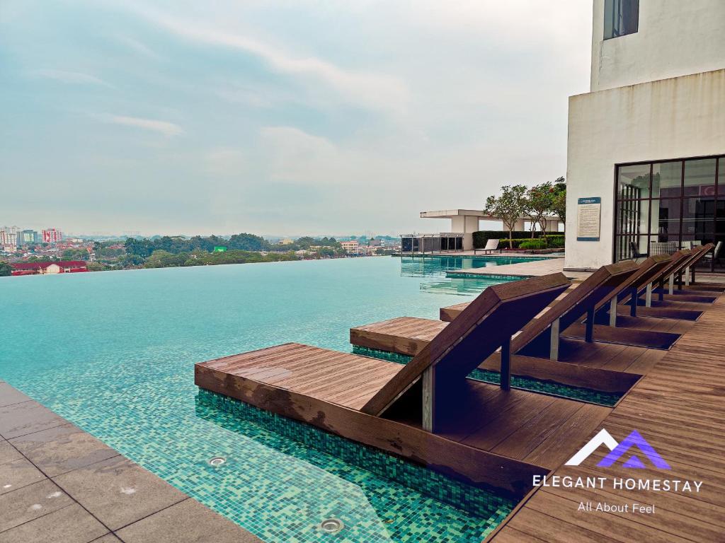 a swimming pool with a view of the water at 1 Tebrau By Elegant Johor Bahru in Johor Bahru