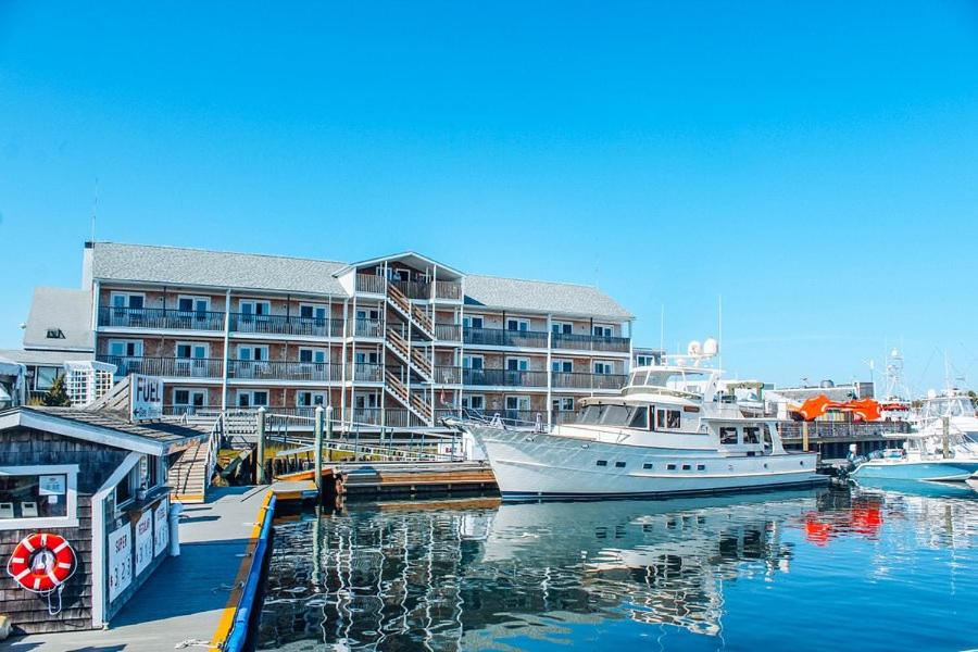 a boat docked at a marina in front of a building at The Hotel at Cape Ann Marina in Gloucester