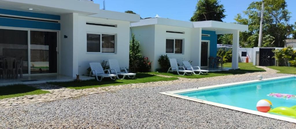 a villa with a swimming pool in front of a house at Casa merengue in Las Terrenas
