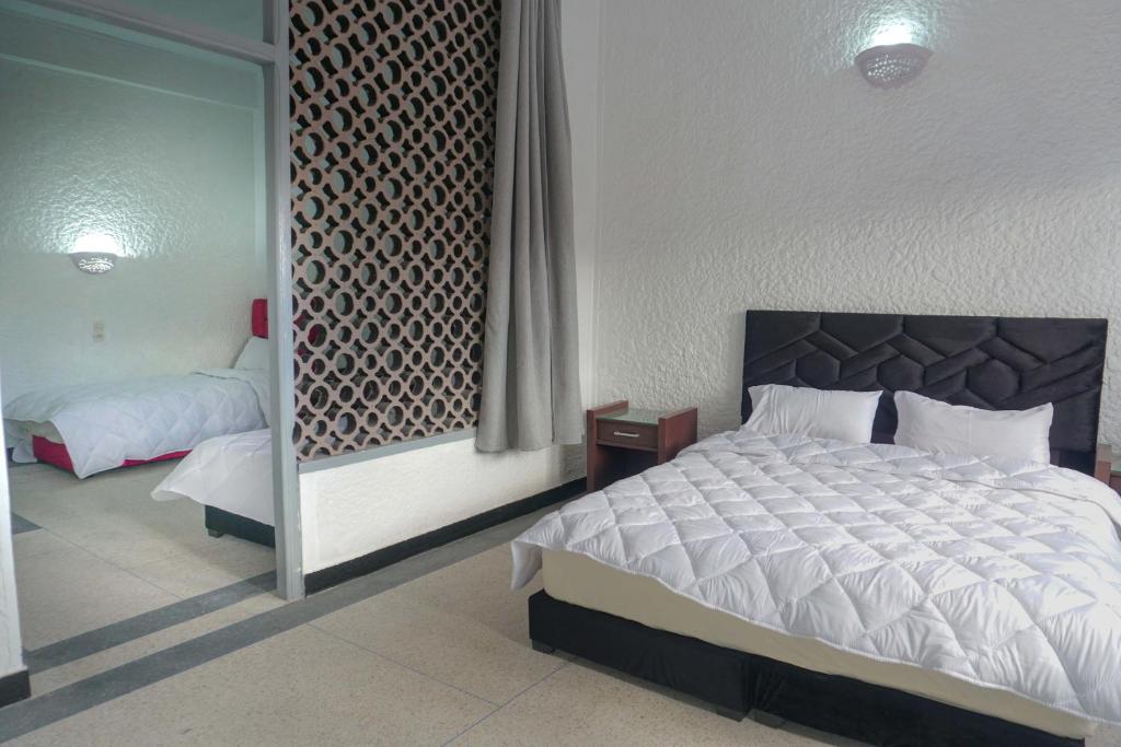 Postel nebo postele na pokoji v ubytování Hotel Warda