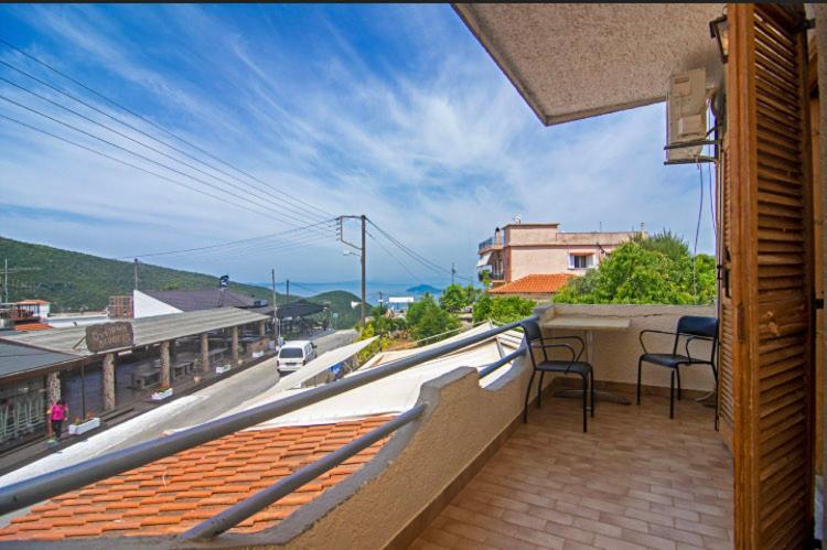 a balcony with chairs and a view of a street at Thaleia view in Perdika