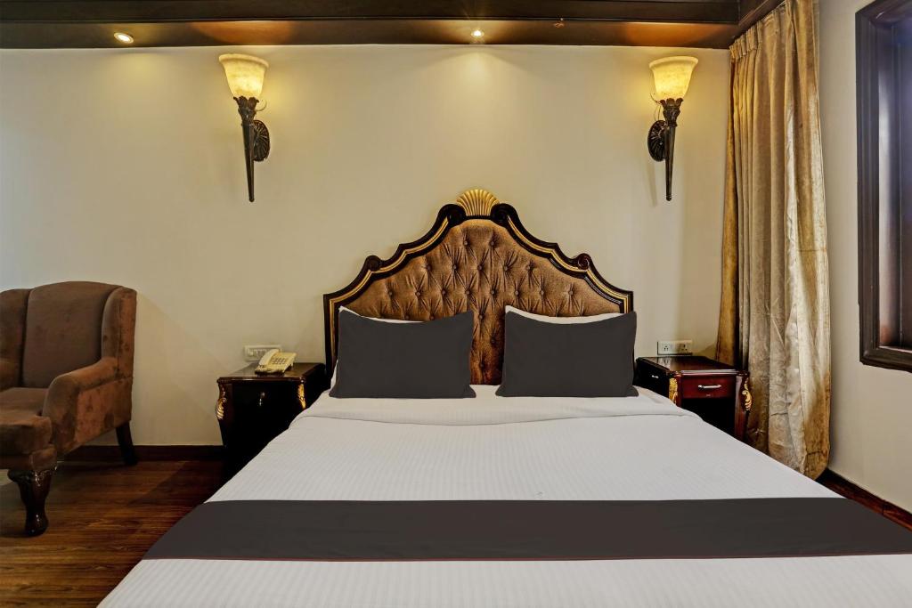 1 dormitorio con 1 cama grande y 1 silla en Townhouse The Royce New Friends Colony, en Nueva Delhi