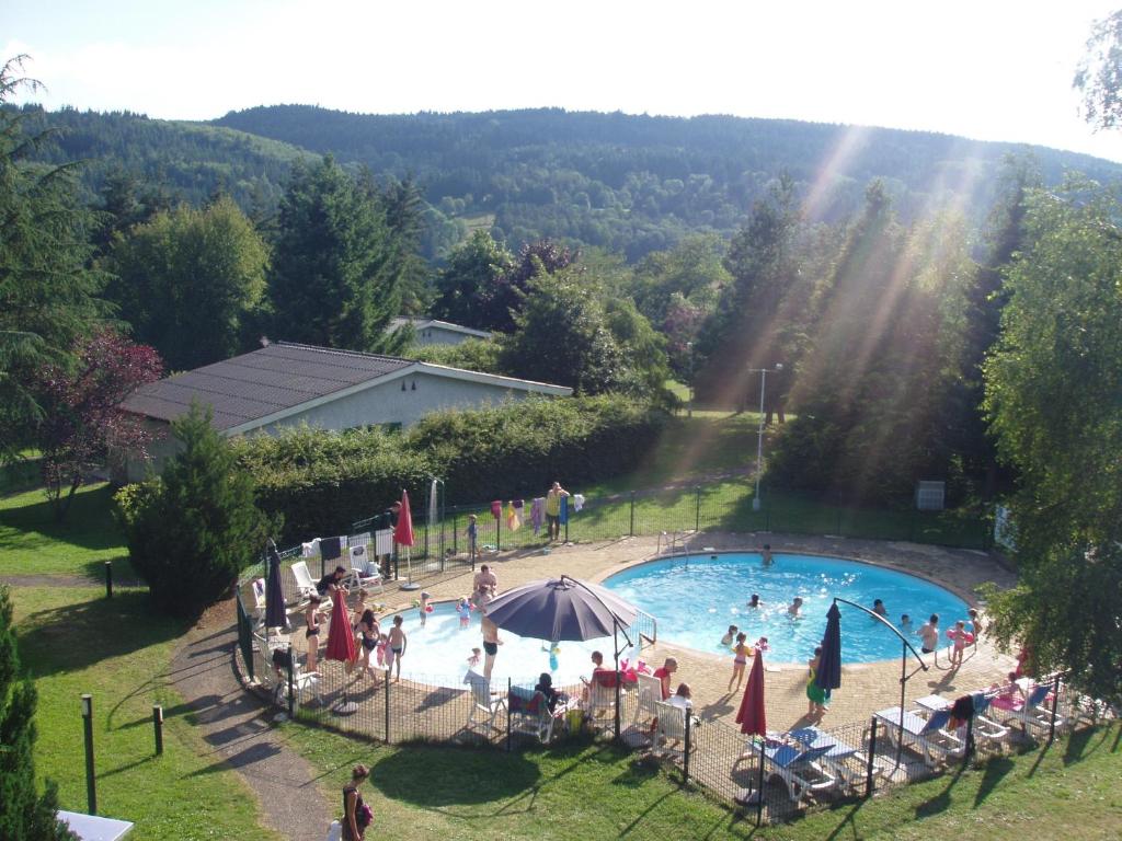 a group of people standing around a swimming pool at VVF Haute Loire Haute Ardèche in Tence