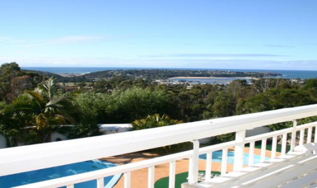 a view of the ocean from the balcony of a house at Kingfisher Motel (Adults only) in Merimbula