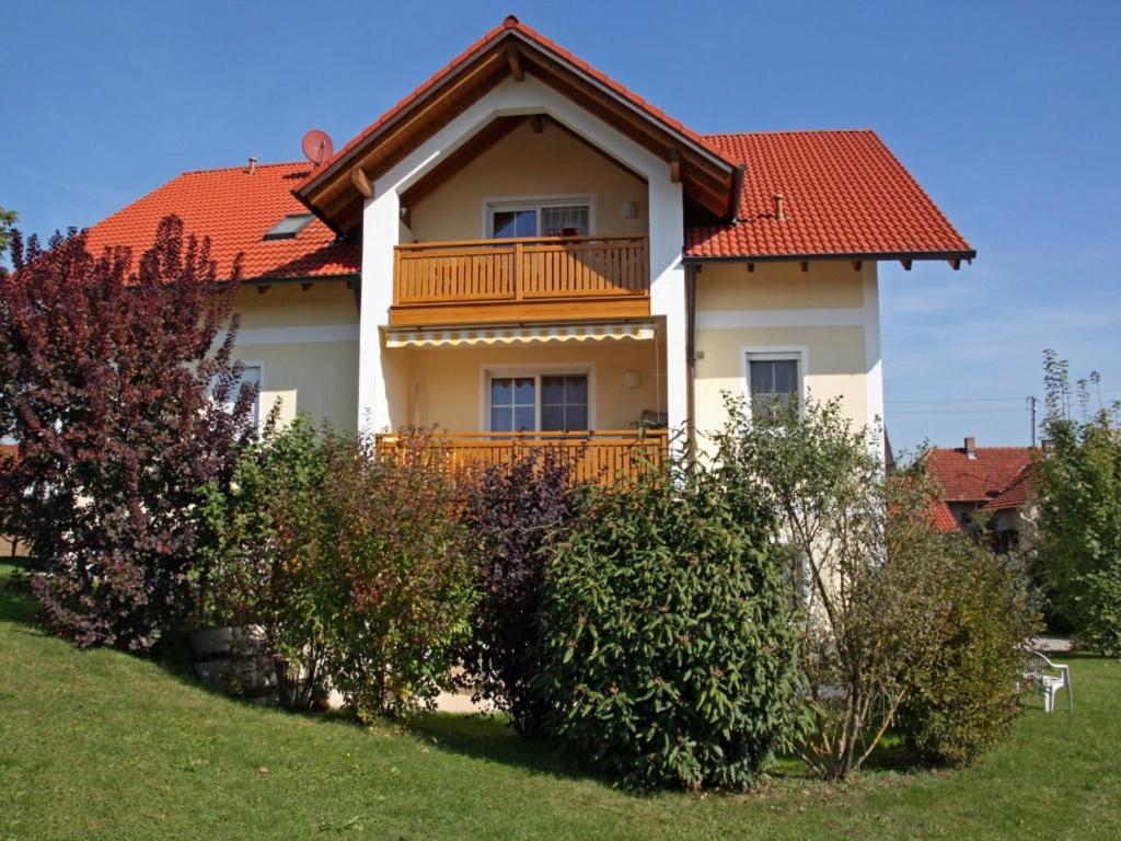 a house with a balcony on top of it at Ferienwohnung Schneider in Ruhstorf