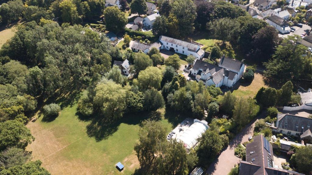 an aerial view of a house with trees and houses at The Old Rectory Cottages in Kings Nympton