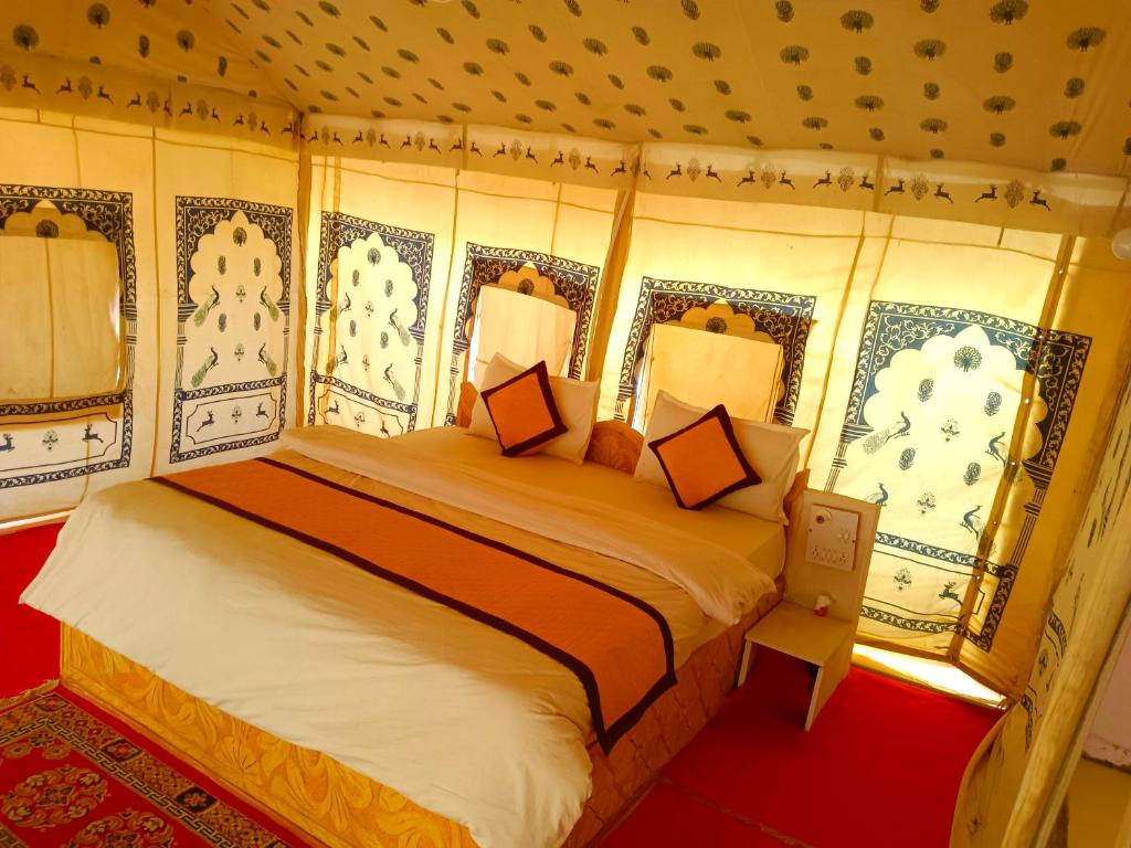 a bedroom with a large bed in a room at Husain desert Safari Camp in Jaisalmer