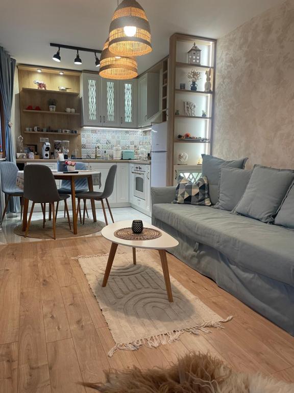 a living room with a couch and a table at Boutique apartment Bansko Bell Tower in Bansko