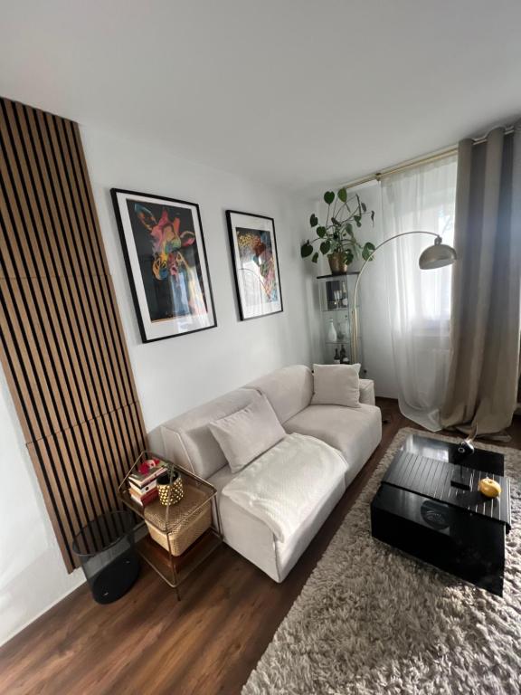 a living room with a white couch and a table at Schlafzimmer der Stille in Bochum