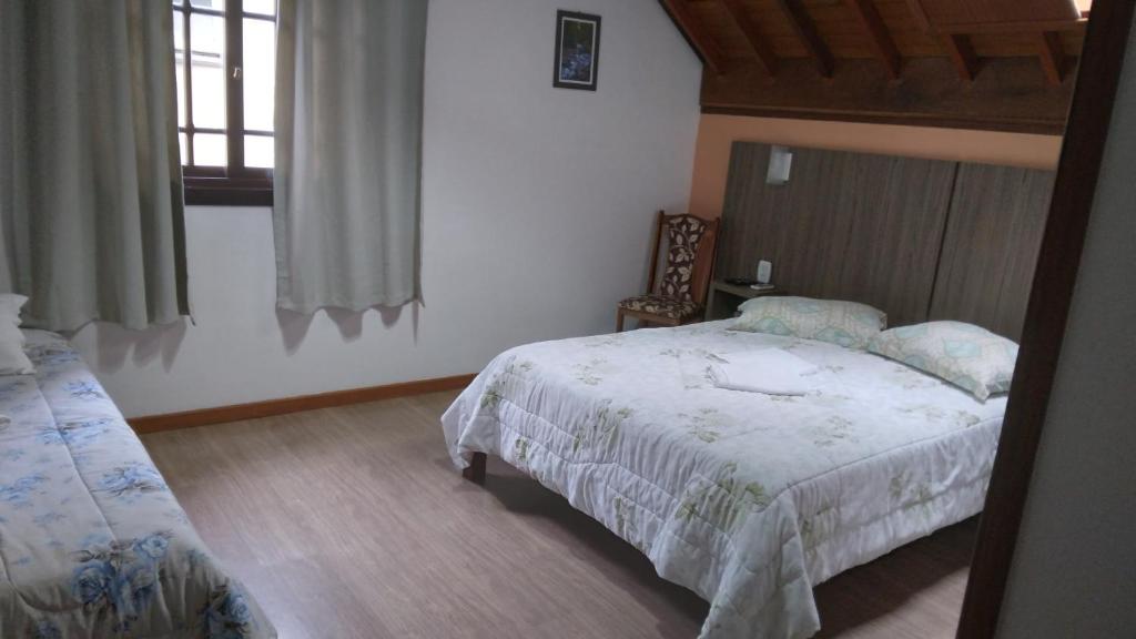 Postel nebo postele na pokoji v ubytování Pousada Genial