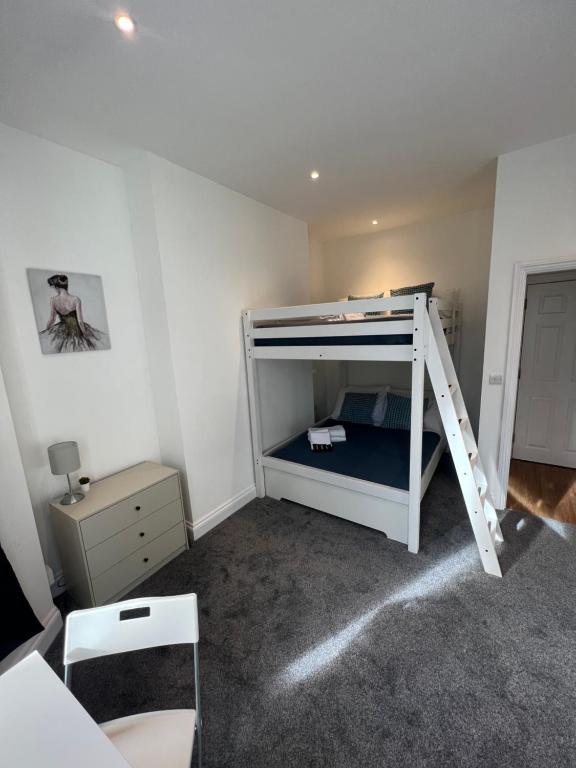 a bedroom with a bunk bed with a ladder at Excellent West Hampstead Studio in London