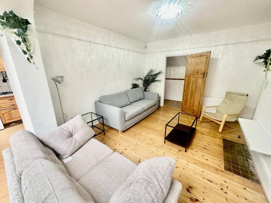 a living room with a couch and a chair at 4 Bed house in Daneby Road,SE6 in Catford