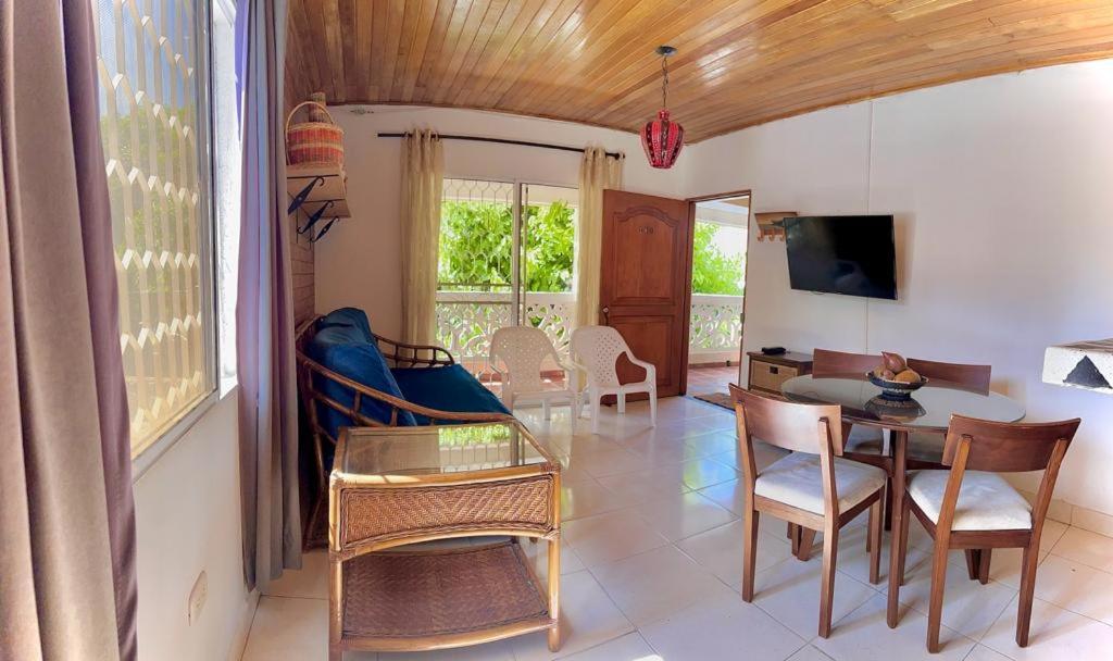 een woonkamer met een tafel en stoelen bij Central-walking distance to the beach/downtown+A/C in Santa Marta