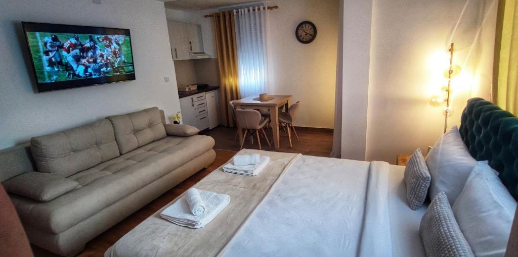 a living room with a couch and a tv on the wall at Soko City Center & Parking Free in Soko Banja