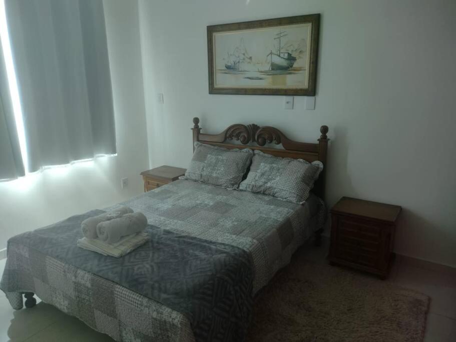 a bedroom with a bed with a stuffed animal on it at Ótimo Apartamento São Lourenço in São Lourenço