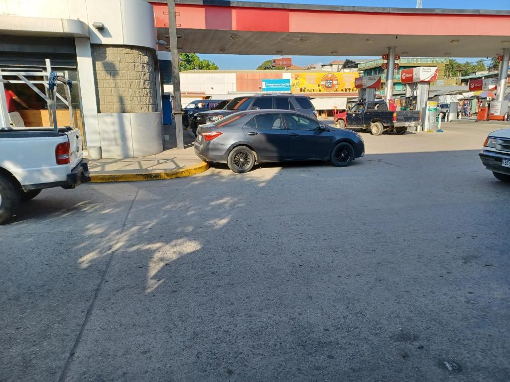 un coche aparcado frente a una gasolinera en Renta Cars Tela en Tela