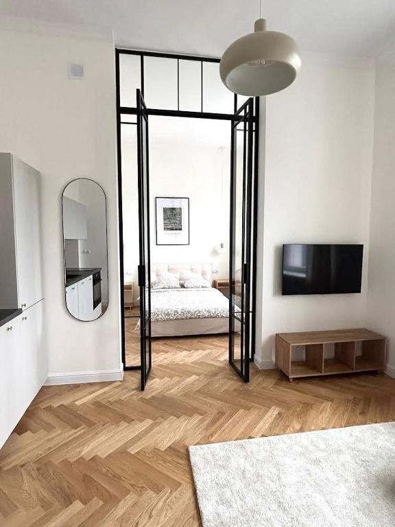 a white room with a bed and a mirror at Old Town Residence , Wi-fi , 2-Beds , Aesthetics - by HIK Apartments in Warsaw