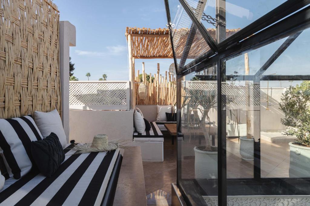 a balcony with a couch and a view of the patio at M-17 Riad & Spa in Marrakesh
