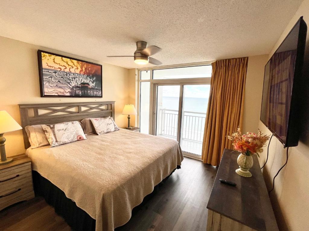 a hotel room with a bed and a large window at Atlantica Resort in Myrtle Beach