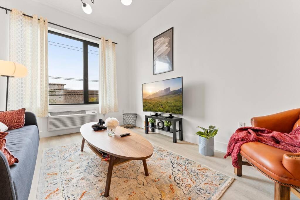 a living room with a couch and a table at Elegant Bd,EWR AIRPT,Nyc, Free Pkng, Prudential CNTR, American Dream Mall in Elizabeth