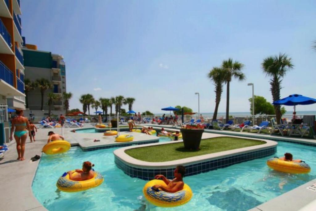 a group of people in tubes in a pool at a resort at Atlantica Resort in Myrtle Beach