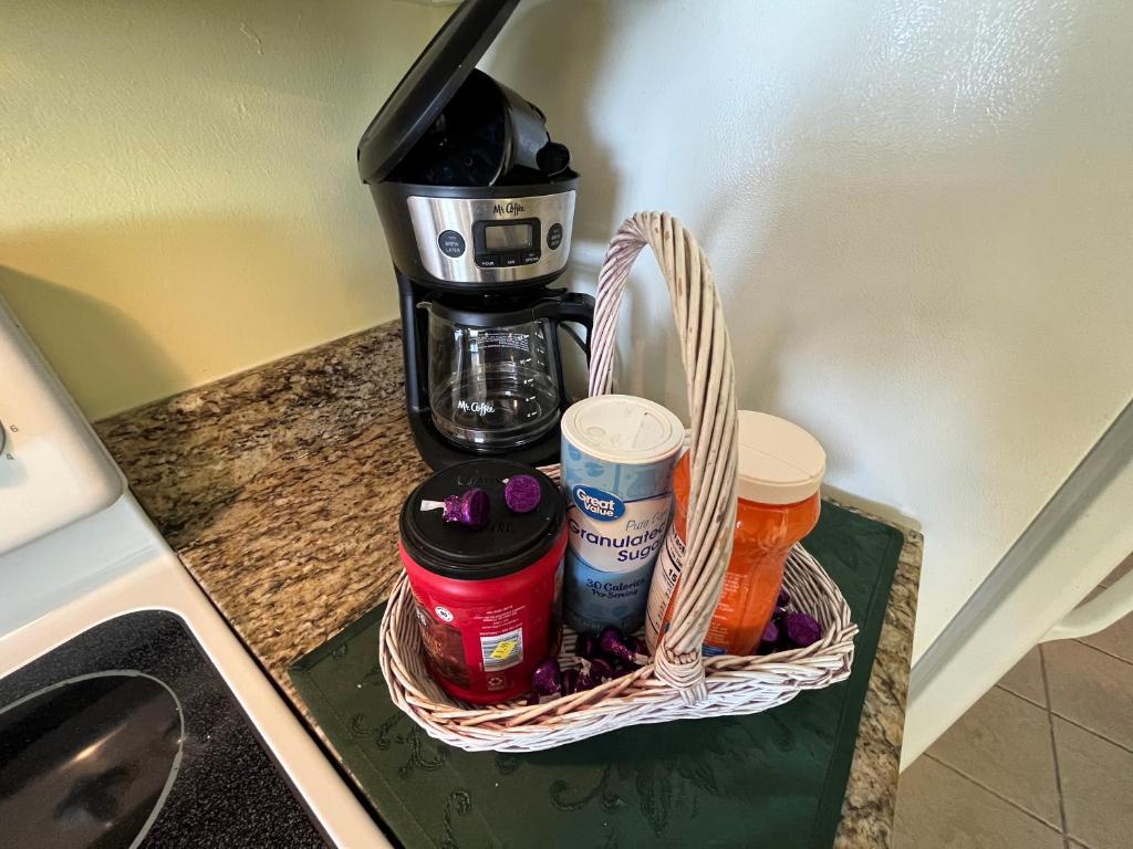a basket sitting on top of a counter next to a coffee maker at Atlantica Resort in Myrtle Beach