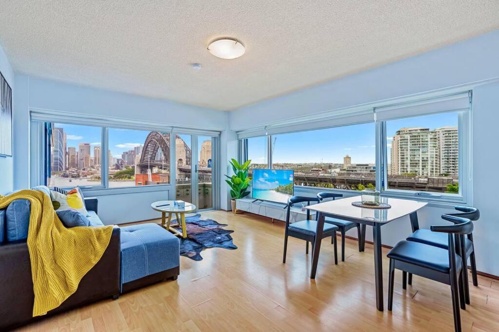 a living room with a couch and a table at Bridge View 2 Bed Apartment at Kirribilli in Sydney