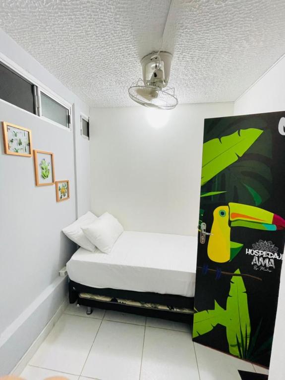 a small bedroom with a bed in a room at HOSTAL AMA in Leticia