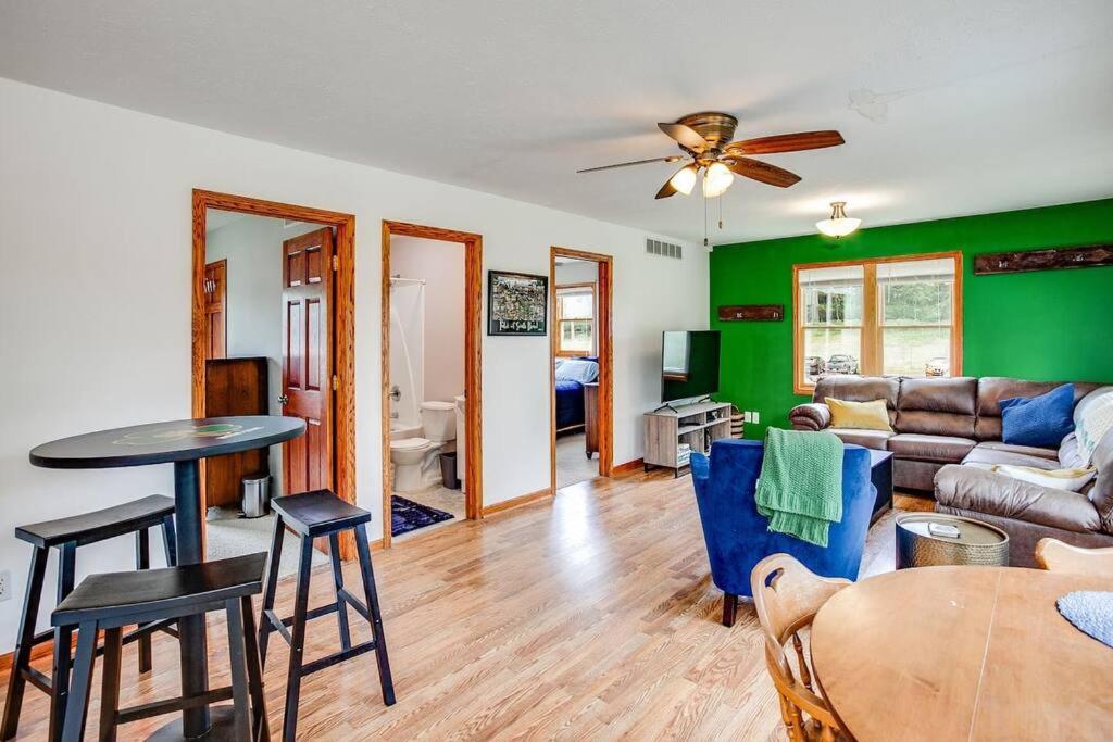 een woonkamer met een bank en een tafel bij On Campus Home Updated Steps From Hesburgh - 10+ in South Bend