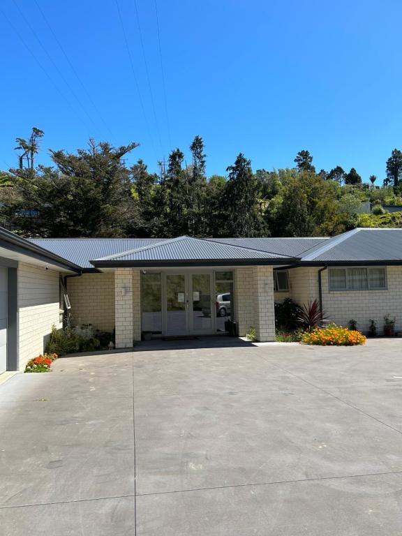 a house with a large driveway in front of it at Almost Heaven BNB in New Plymouth